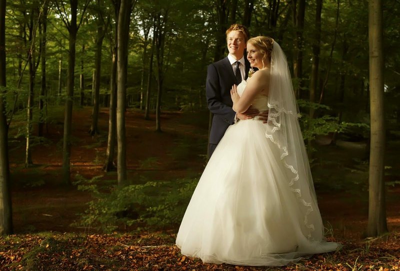 Wedding portrait in a forest in Copenhagen, Denmark.